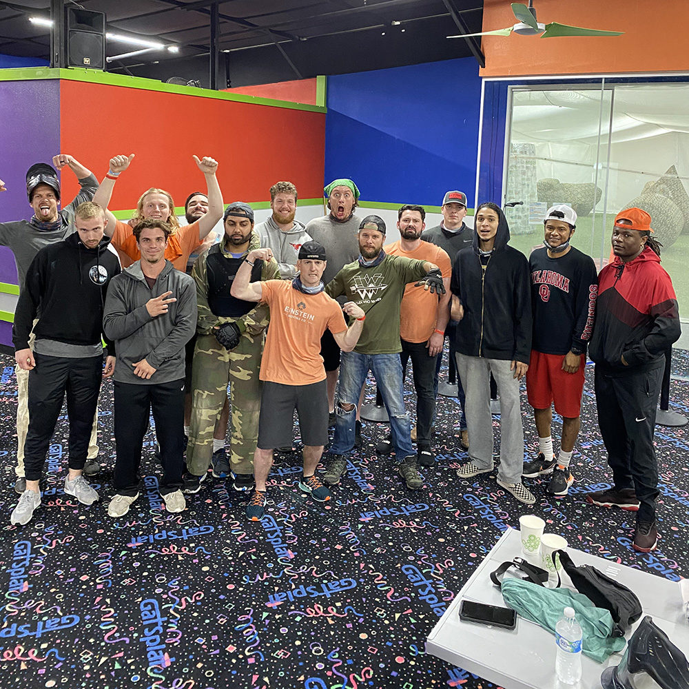 Dallas movers pose outside of a paintball party