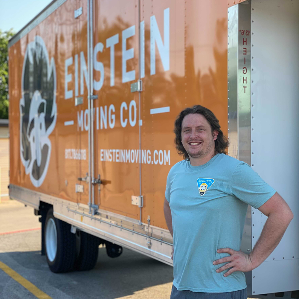 McCullough Newton, Fort Worth manager, smiles in front of an Einstein moving truck
