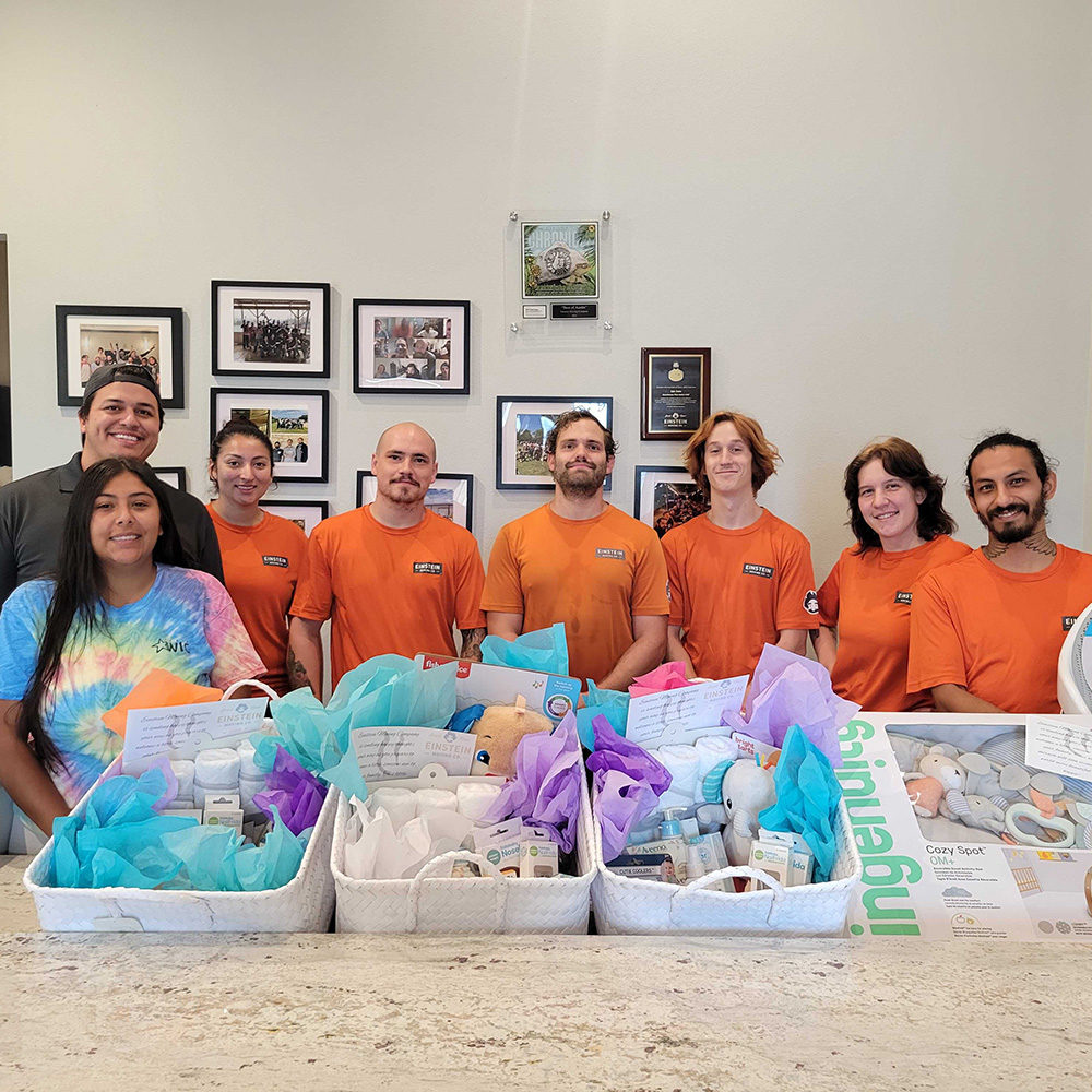 Leander movers stand together at the WIC Drive Through Baby Shower