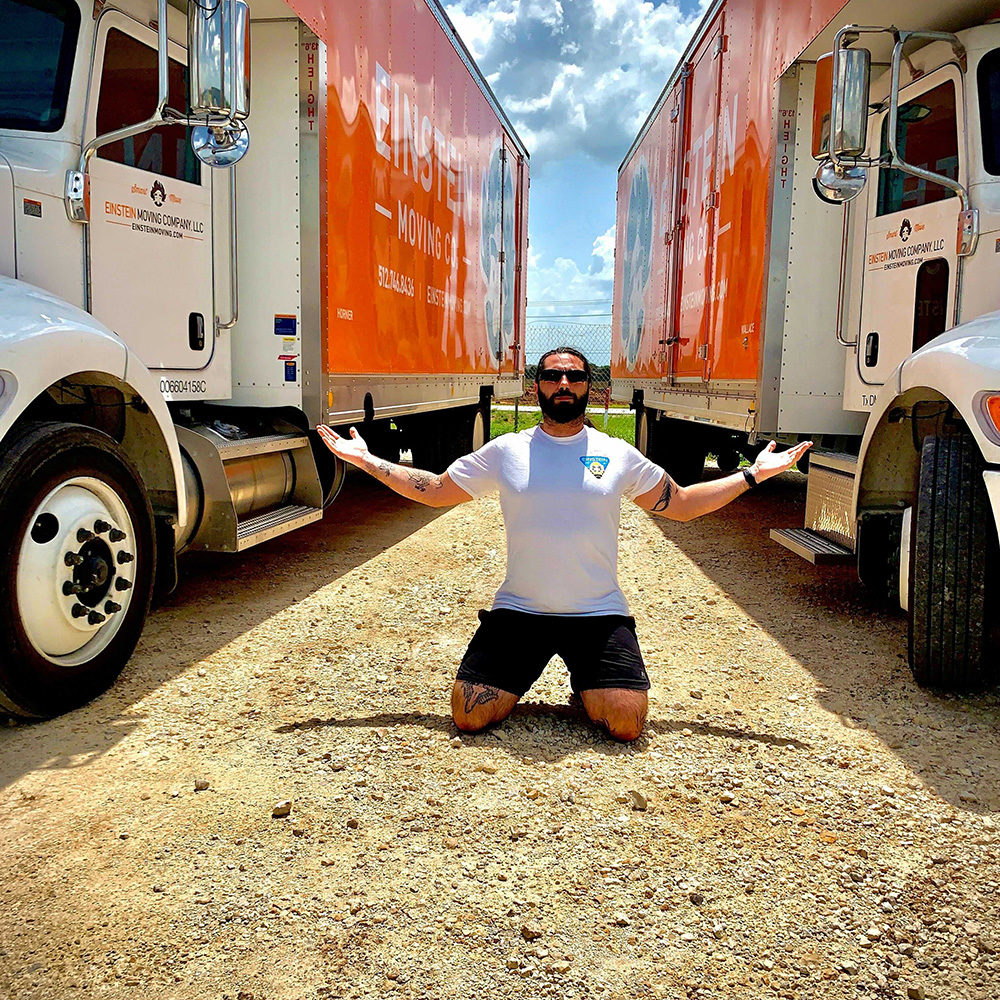 Leander manager Frank kneels between two Einstein trucks