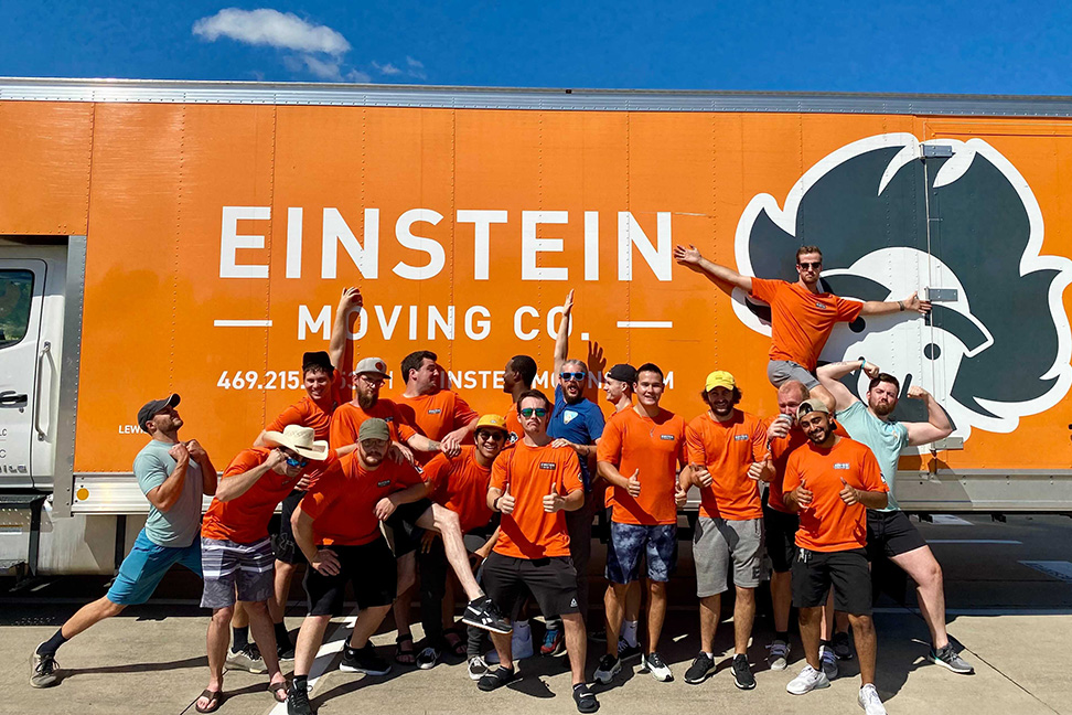 Einstein's McKinney movers pose in front of a moving truck